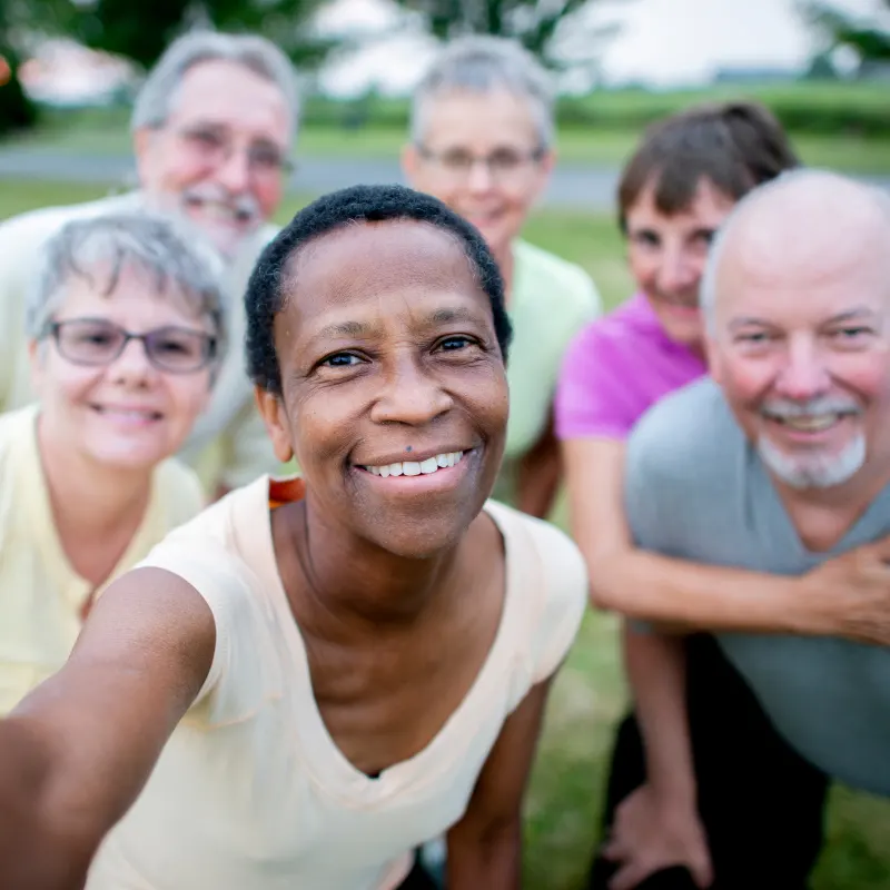 Group of seniors smiling together outdoors